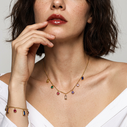 Rainbow CZ Charm Necklace - multicolor round and baguette CZ drops on gold chain, close up front view