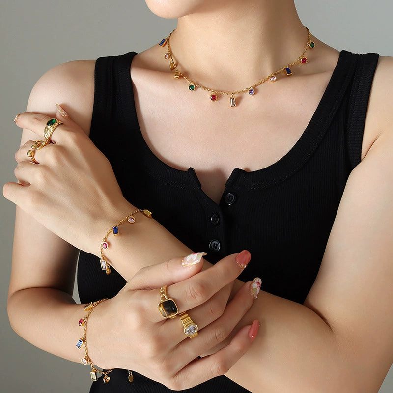 Rainbow CZ Charm Necklace and Bracelet - colorful zirconia charms on gold chain worn with rings, black top